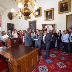 Governor Phil Scott presenting the signed Proclamation to VSHA Board of Commissioners Chair , Caprice Hover.